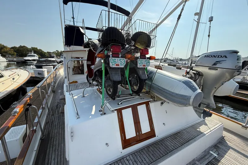 Margo Yacht Photos Pics 1996 Grand Banks 42 Classic yacht with motorcycles and dinghy on deck.