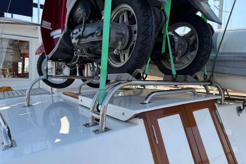 Margo Yacht Photos Pics Motorbike secured on 1996 Grand Banks 42 Classic yacht deck with green straps.