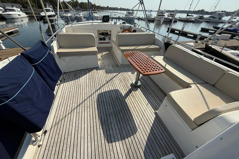 Margo Yacht Photos Pics Flybridge of 1996 Grand Banks 42 Classic yacht with seating and table, docked at marina.
