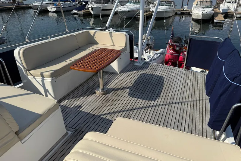 Margo Yacht Photos Pics 1996 Grand Banks 42 Classic yacht deck with seating and table, docked at marina.