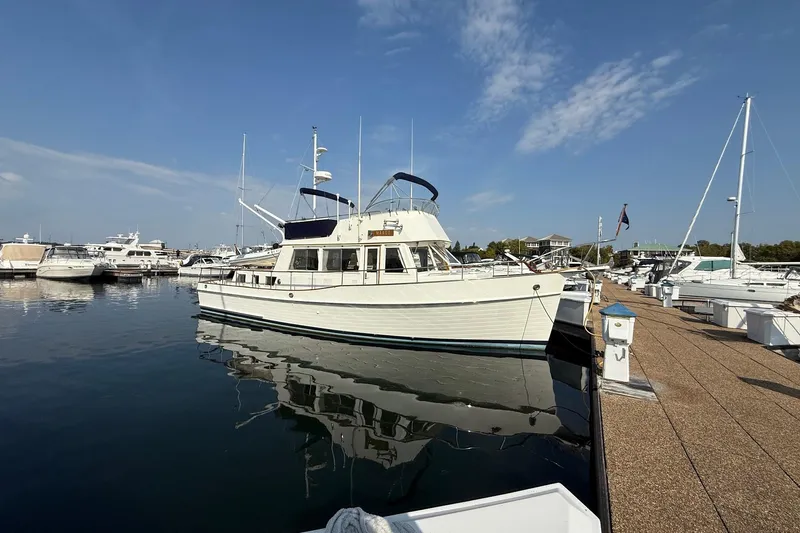 Margo Yacht Photos Pics 1996 Grand Banks 42 Classic yacht docked in a marina under a clear blue sky.