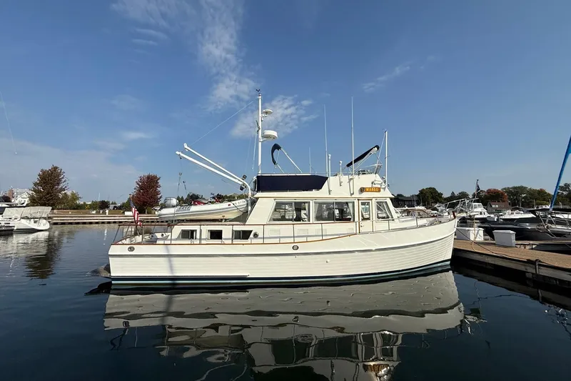 Margo Yacht Photos Pics 1996 Grand Banks 42 Classic yacht docked in a marina under clear blue skies.