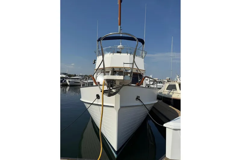 Margo Yacht Photos Pics 1996 Grand Banks 42 Classic yacht docked at marina under clear blue sky.