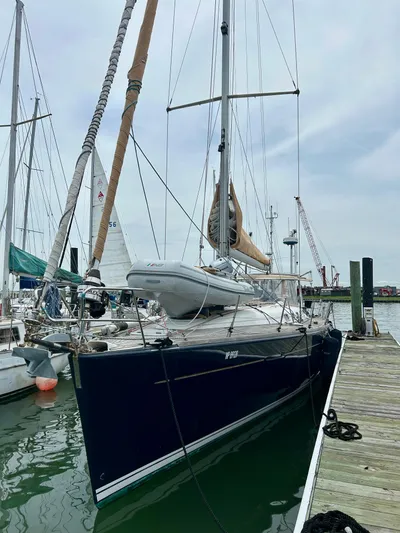 Blue Moon Yacht Photos Pics 2003 Beneteau First 47.7 sailboat docked at marina, featuring sleek design and tall mast.