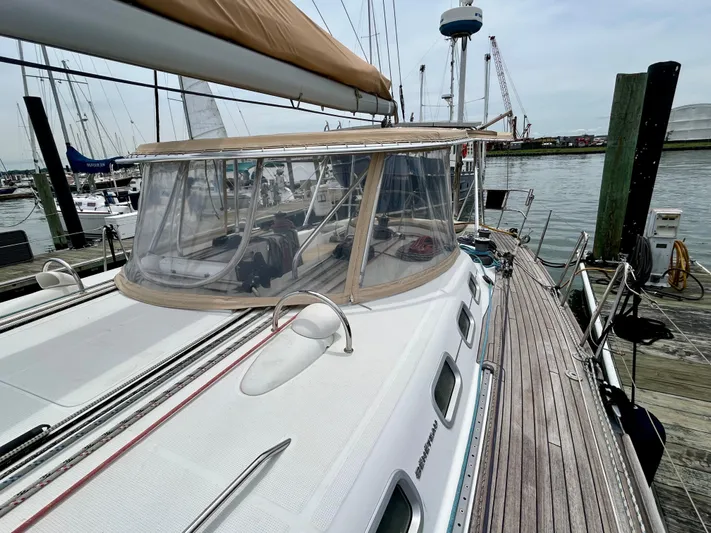 Blue Moon Yacht Photos Pics 2003 Beneteau First 47.7 sailboat docked at marina, featuring sleek design and spacious deck.