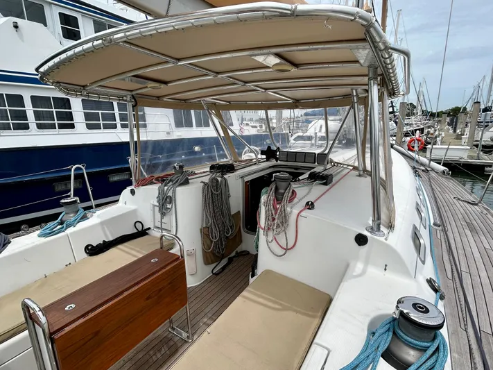 Blue Moon Yacht Photos Pics Beneteau First 47.7 sailboat cockpit, 2003 model, docked at marina with canopy and seating.