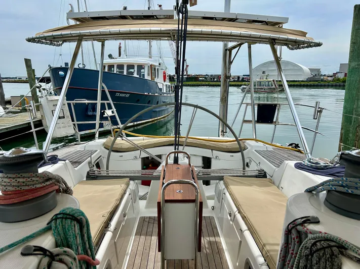 Blue Moon Yacht Photos Pics Beneteau First 47.7 sailboat cockpit, 2003 model, docked in a marina with nearby boats.