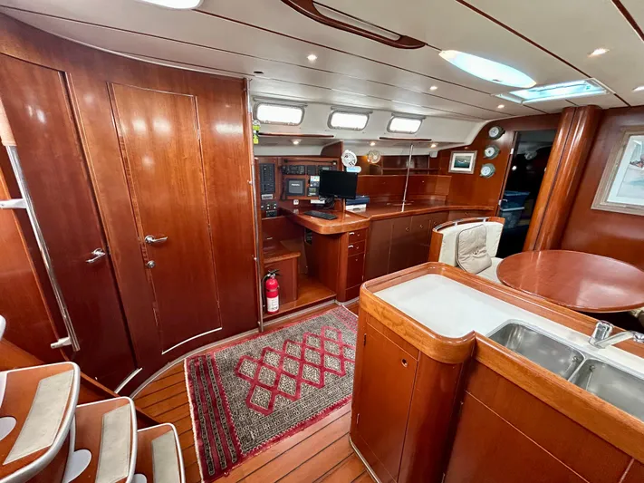 Blue Moon Yacht Photos Pics Interior of 2003 Beneteau First 47.7 yacht with wood finish and modern amenities.