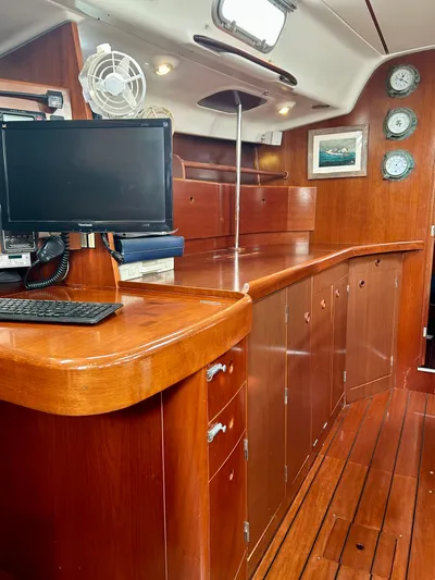 Blue Moon Yacht Photos Pics Interior of 2003 Beneteau First 47.7 yacht with wooden cabinetry and navigation equipment.