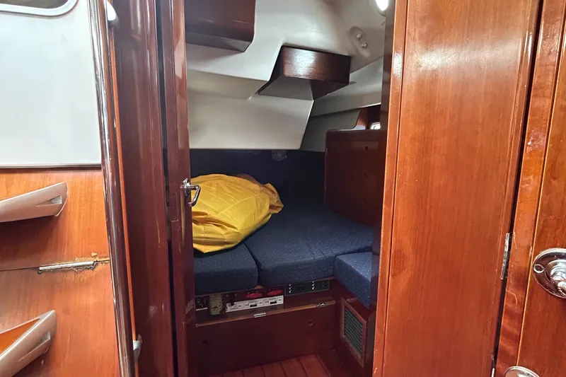 Blue Moon Yacht Photos Pics Cozy cabin interior of 2003 Beneteau First 47.7 sailboat with wooden finish.