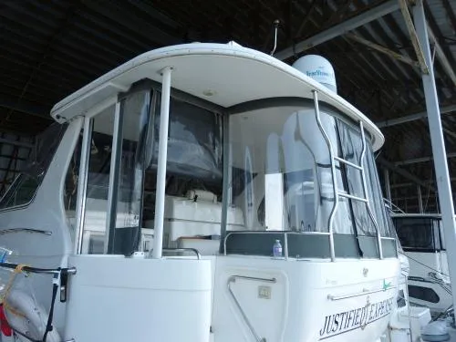  Yacht Photos Pics 2001 Cruisers Yachts 4450 Express Motoryacht docked in a covered marina.