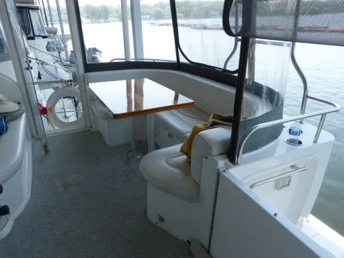 Yacht Photos Pics 2001 Cruisers Yachts 4450 Express Motoryacht interior with seating and table, overlooking water.