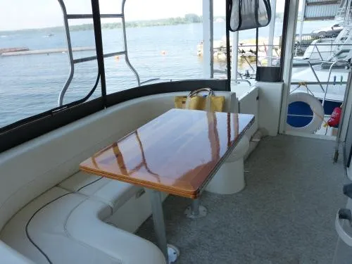  Yacht Photos Pics 2001 Cruisers Yachts 4450 Express Motoryacht interior with polished table and lake view.