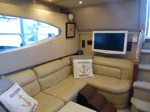  Yacht Photos Pics Luxurious interior of 2001 Cruisers Yachts 4450 Express Motoryacht with beige seating and TV.