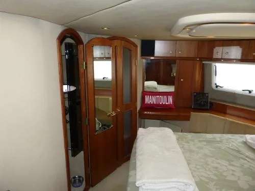  Yacht Photos Pics Luxurious cabin interior of 2001 Cruisers Yachts 4450 Express Motoryacht with wooden accents.