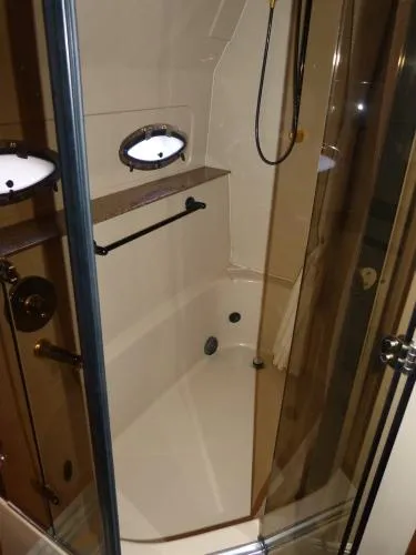  Yacht Photos Pics 2001 Cruisers Yachts 4450 Express Motoryacht bathroom with shower and porthole window.