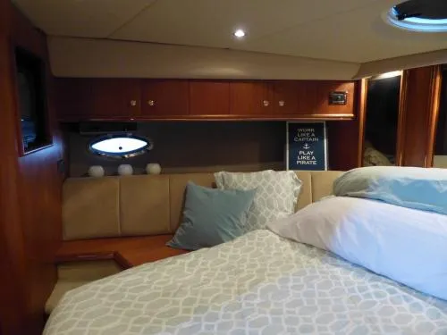  Yacht Photos Pics Luxurious bedroom interior of 2001 Cruisers Yachts 4450 Express Motoryacht with cozy bedding.