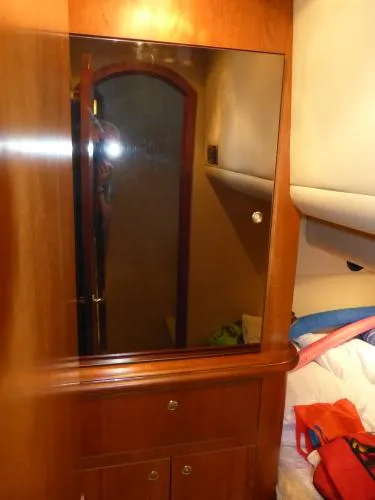  Yacht Photos Pics Interior of 2001 Cruisers Yachts 4450 Express Motoryacht with wooden cabinetry and mirror.