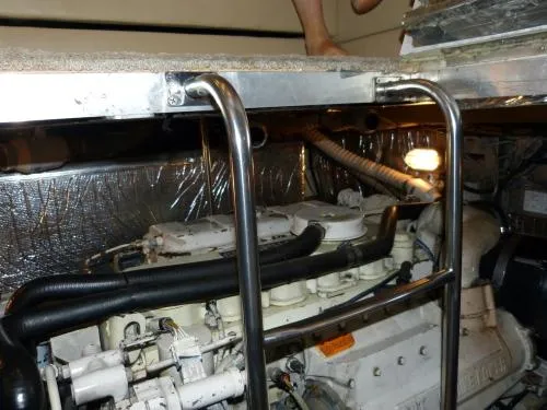  Yacht Photos Pics Engine room of 2001 Cruisers Yachts 4450 Express Motoryacht with visible machinery and pipes.