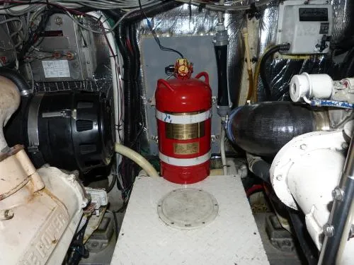  Yacht Photos Pics Engine room of 2001 Cruisers Yachts 4450 Express Motoryacht with fire extinguisher.
