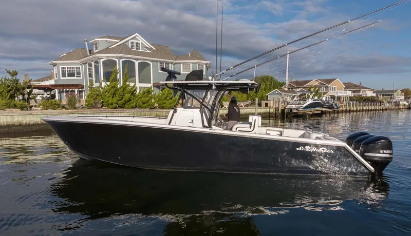 Mr Fish Yacht Photos Pics 2016 SeaHunter 35 Tournament boat docked near waterfront homes.