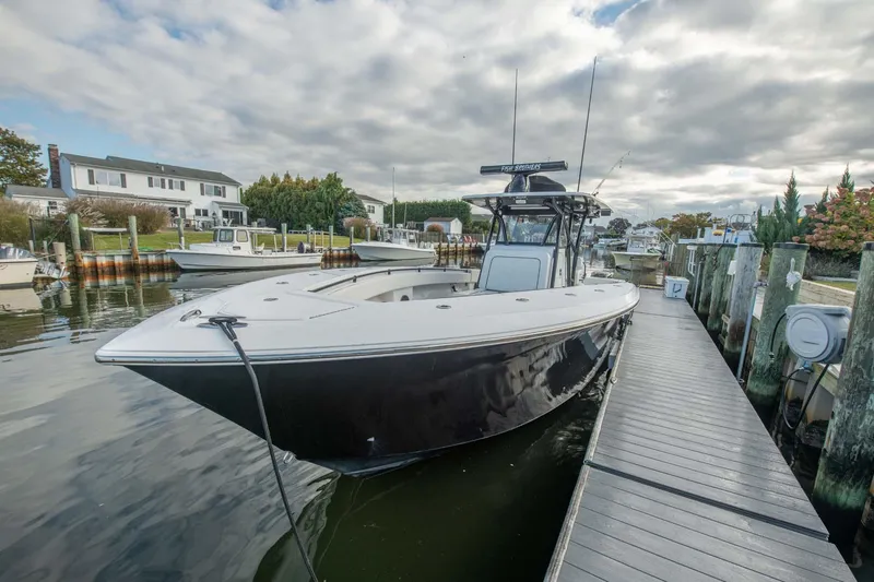Mr Fish Yacht Photos Pics 2016 SeaHunter 35 Tournament boat docked in a marina under cloudy skies.