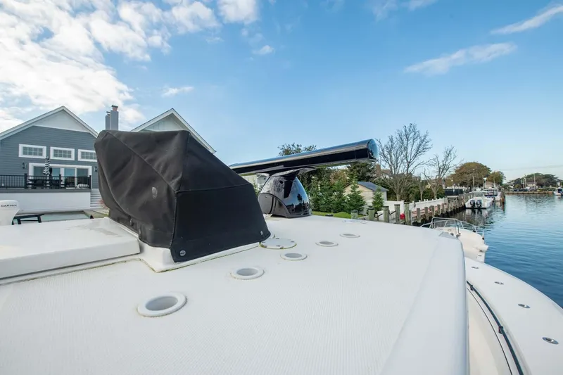 Mr Fish Yacht Photos Pics 2016 SeaHunter 35 Tournament boat docked by waterfront homes.