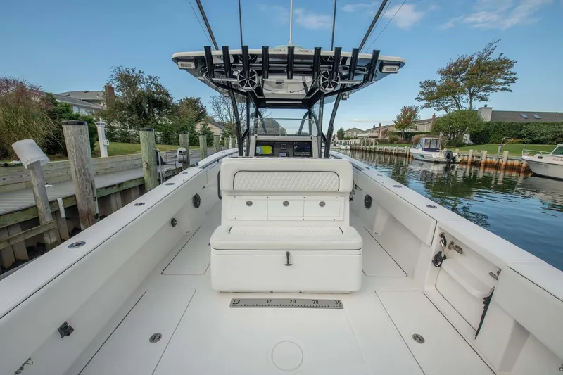 Mr Fish Yacht Photos Pics 2016 SeaHunter 35 Tournament boat, spacious deck, docked in a serene canal setting.