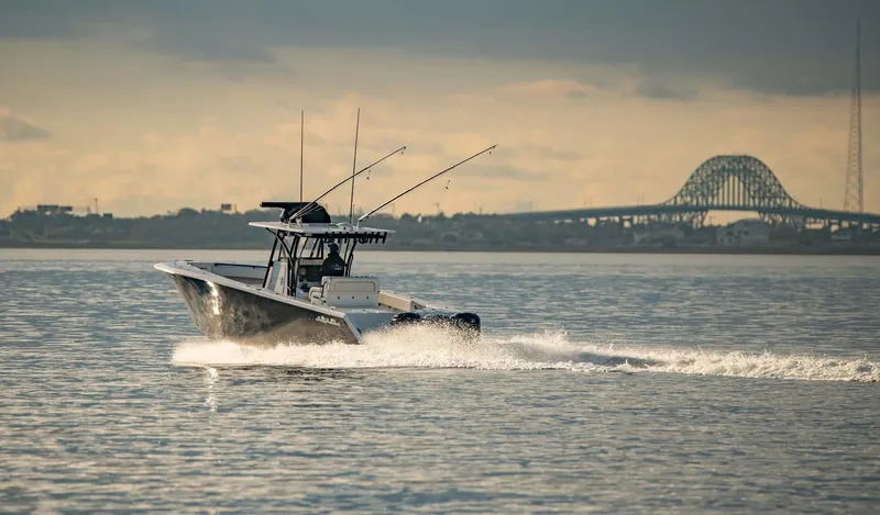 Mr Fish Yacht Photos Pics 2016 SeaHunter 35 Tournament boat cruising on water with bridge in background.