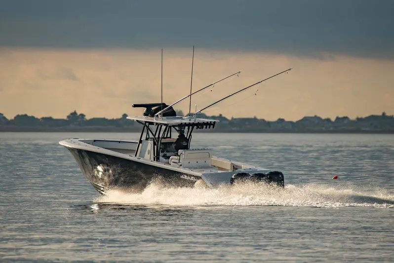 Mr Fish Yacht Photos Pics 2016 SeaHunter 35 Tournament boat cruising on calm water at sunset.