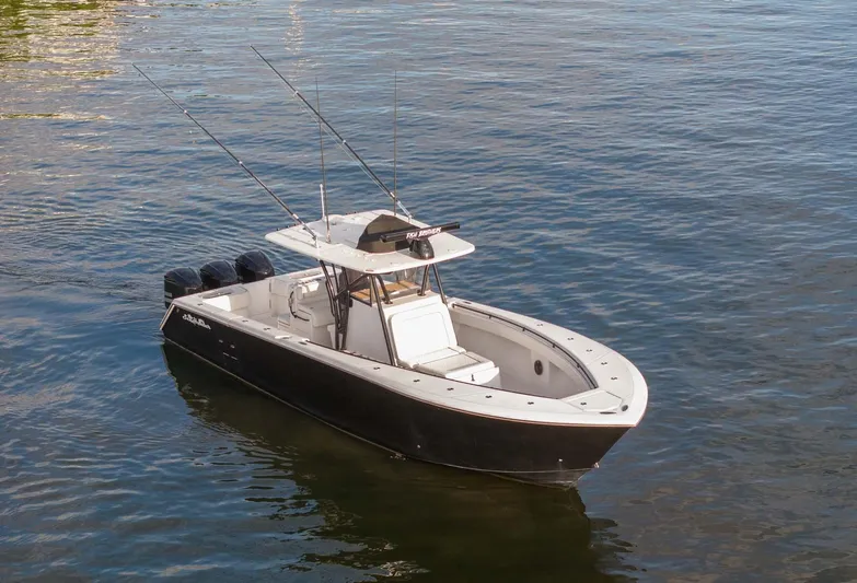 Mr Fish Yacht Photos Pics 2016 SeaHunter 35 Tournament boat on calm water, equipped with fishing rods.