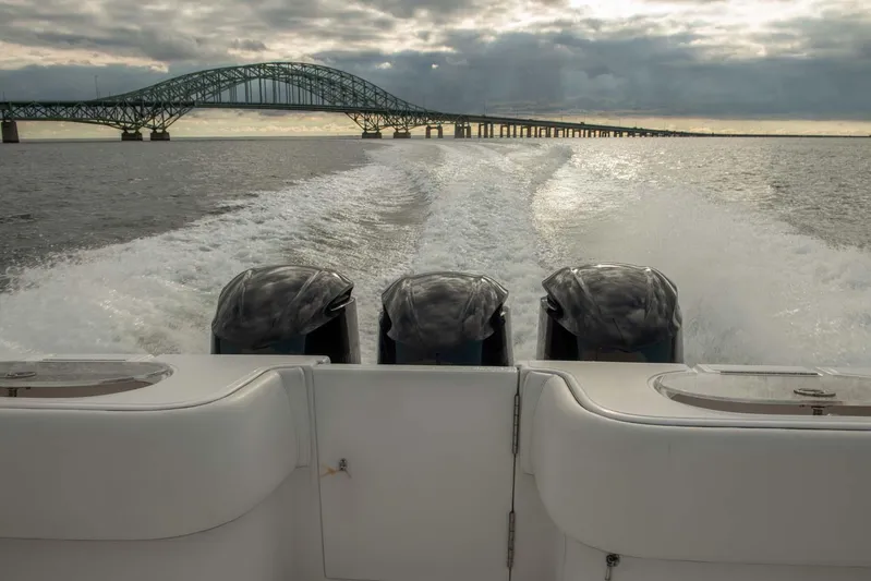 Mr Fish Yacht Photos Pics 2016 SeaHunter 35 Tournament boat cruising under a bridge at sunset.