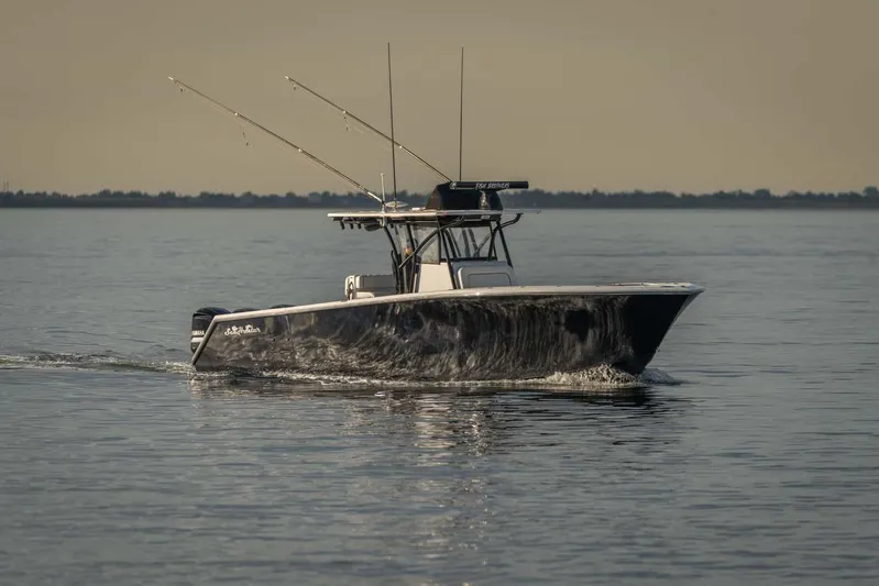 Mr Fish Yacht Photos Pics 2016 SeaHunter 35 Tournament boat cruising on calm water at sunset.