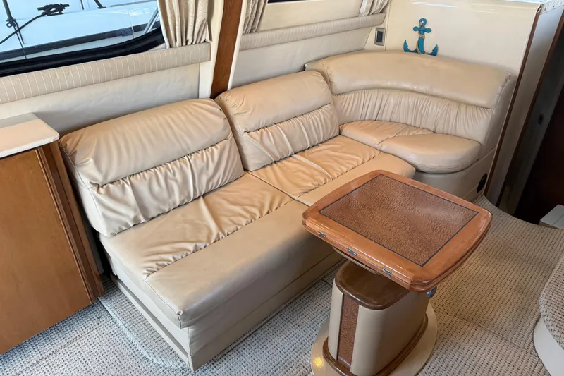  Yacht Photos Pics Interior of 2005 Meridian 341 Sedan with beige leather seating and wooden table.