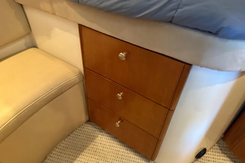  Yacht Photos Pics 2005 Meridian 341 Sedan interior with wooden drawers and beige seating.