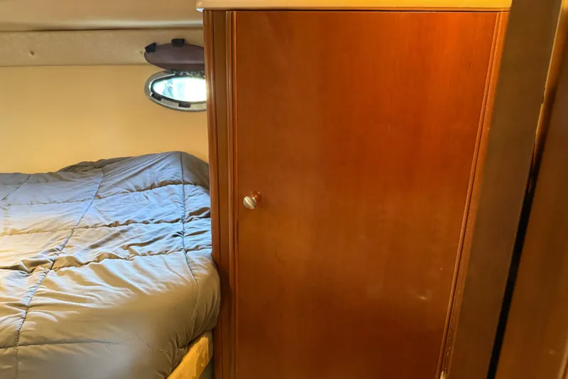  Yacht Photos Pics 2005 Meridian 341 Sedan interior with bed and wooden cabinet.