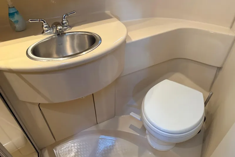  Yacht Photos Pics Compact bathroom in a 2005 Meridian 341 Sedan yacht with sink and toilet.