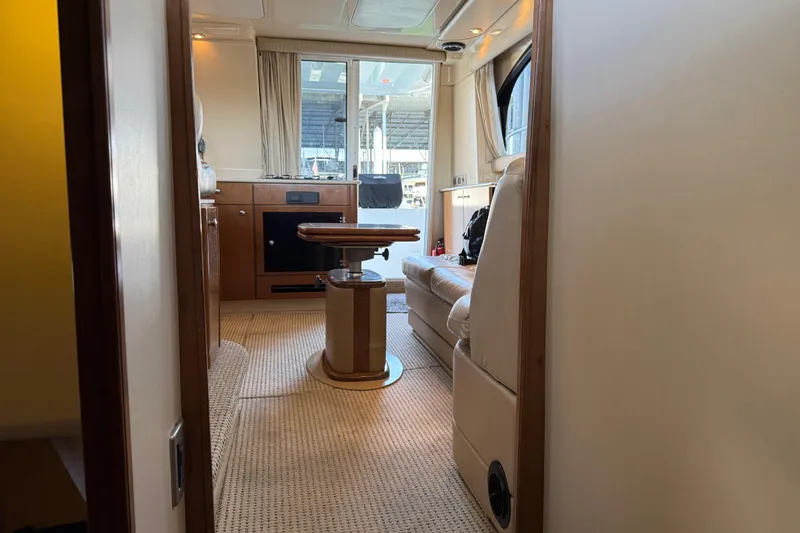  Yacht Photos Pics Interior of 2005 Meridian 341 Sedan yacht, featuring cozy seating and elegant wood finishes.