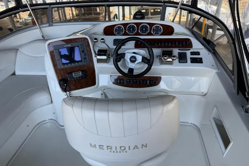  Yacht Photos Pics Cockpit of 2005 Meridian 341 Sedan yacht with steering wheel and navigation controls.