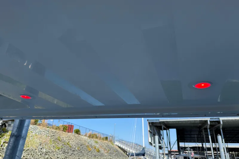  Yacht Photos Pics Underneath view of a 2005 Meridian 341 Sedan with red lights, docked near a marina.