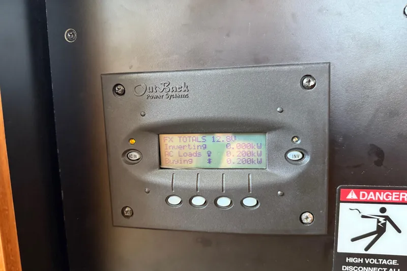  Yacht Photos Pics OutBack Power Systems display on 2005 Meridian 341 Sedan, showing power metrics and warning label.