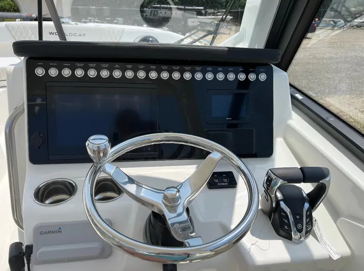  Yacht Photos Pics 2024 World Cat 260 DC-X boat dashboard with steering wheel and controls.