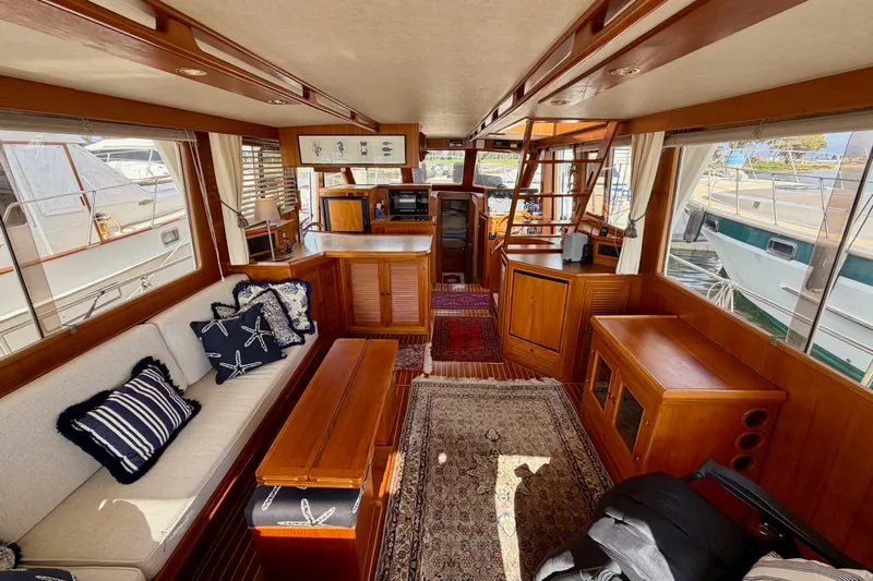 Queenie Yacht Photos Pics Interior of 1988 Offshore Yachts 48 Sedan, featuring cozy seating and nautical decor.