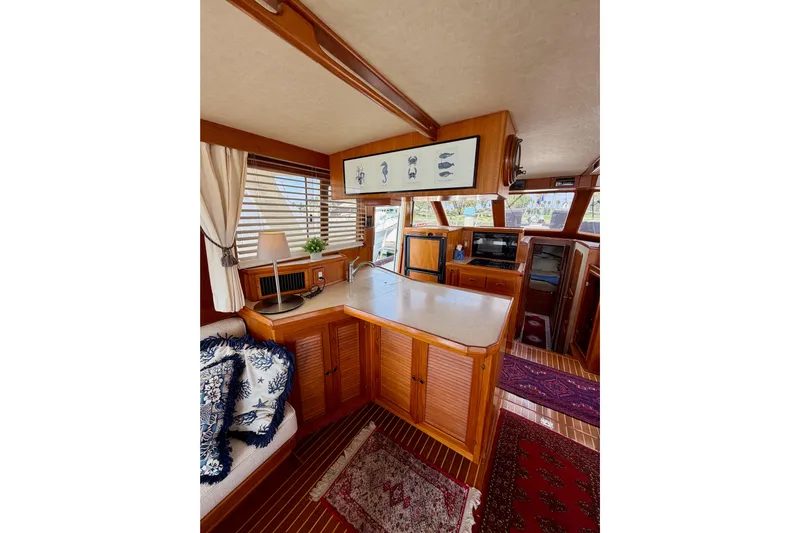 Queenie Yacht Photos Pics Interior of 1988 Offshore Yachts 48 Sedan, featuring wood cabinetry and nautical decor.