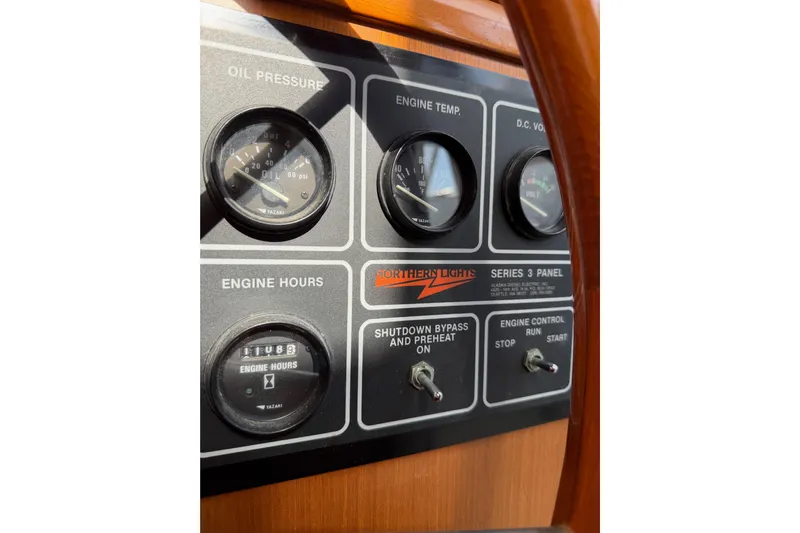 Queenie Yacht Photos Pics Control panel of a 1988 Offshore Yachts 48 Sedan, featuring gauges and switches.