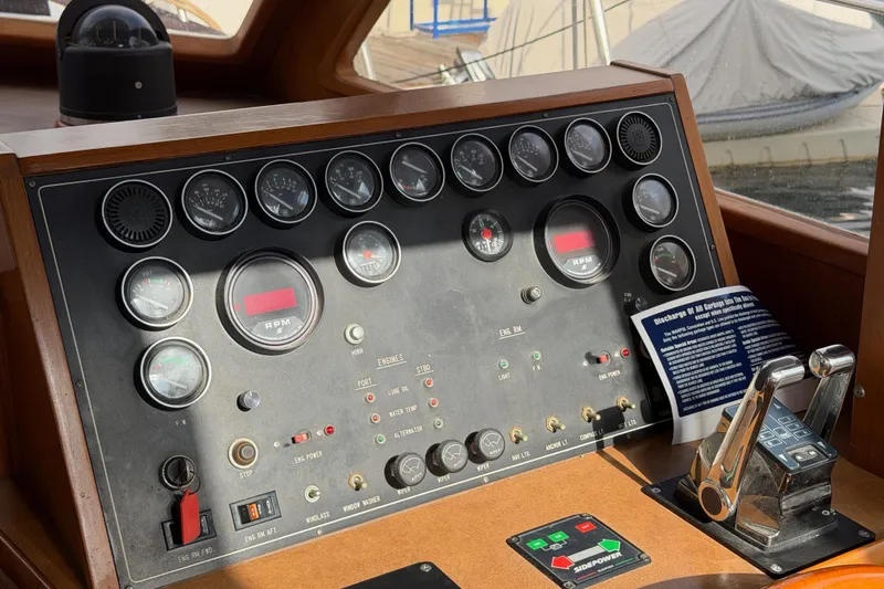 Queenie Yacht Photos Pics Control panel of a 1988 Offshore Yachts 48 Sedan with gauges and throttle levers.
