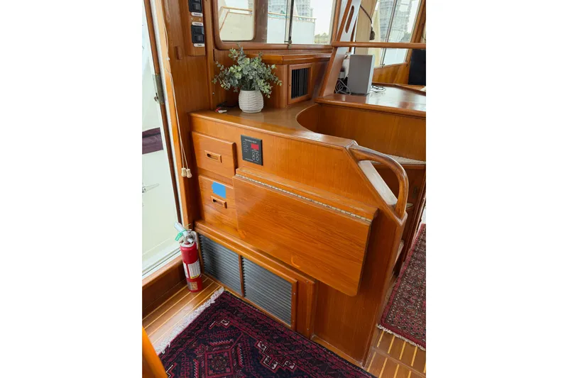 Queenie Yacht Photos Pics 1988 Offshore Yachts 48 Sedan interior with wooden cabinetry and fire extinguisher.