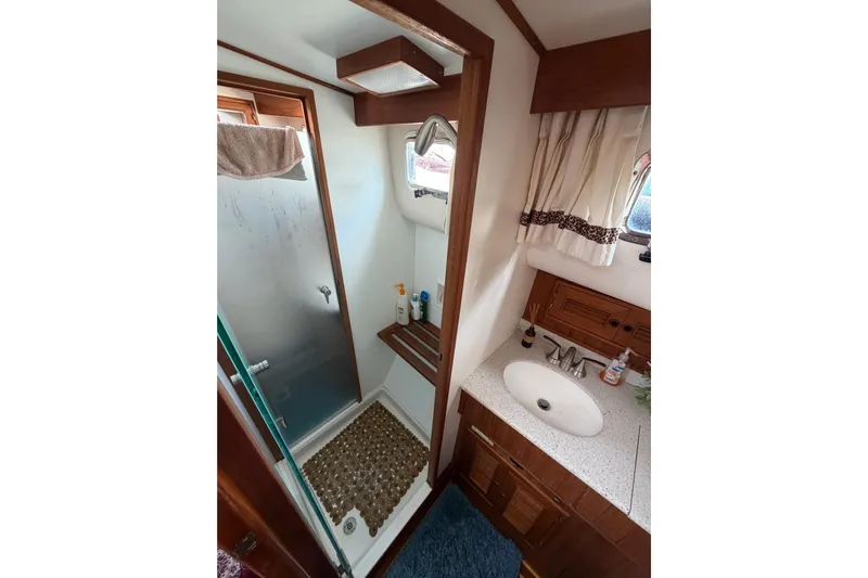 Queenie Yacht Photos Pics Bathroom interior of 1988 Offshore Yachts 48 Sedan with shower and sink.