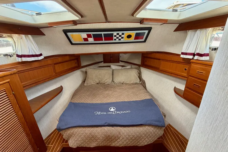 Queenie Yacht Photos Pics Cozy cabin interior of 1988 Offshore Yachts 48 Sedan with nautical decor and skylights.