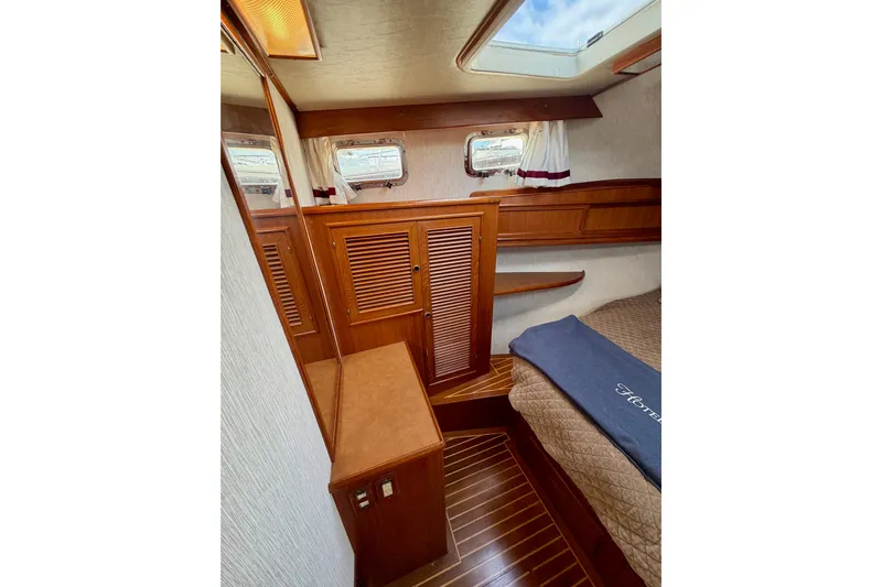 Queenie Yacht Photos Pics 1988 Offshore Yachts 48 Sedan cabin interior with wood paneling and skylight.
